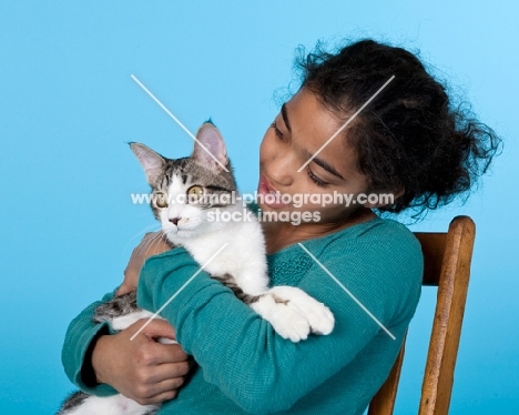 tabby and white cat with girl