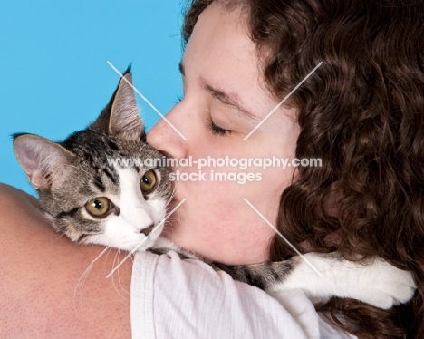 girl kissing tabby and white cat