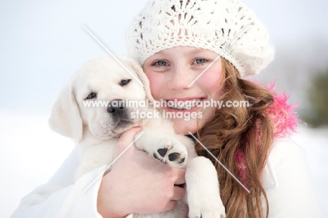 Labrador puppy with proud girl