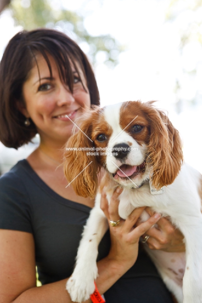 woman holding Cavalier King Charles Spaniel