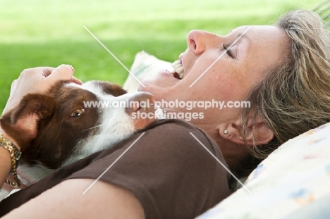 Woman resting with her Border Collie