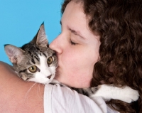 Picture of girl kissing tabby and white cat